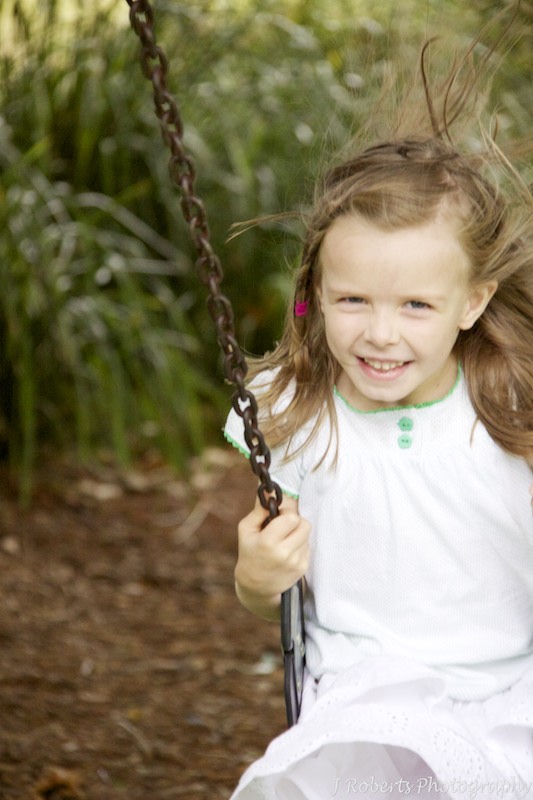 Little girl on the swings - family portrait photography sydney